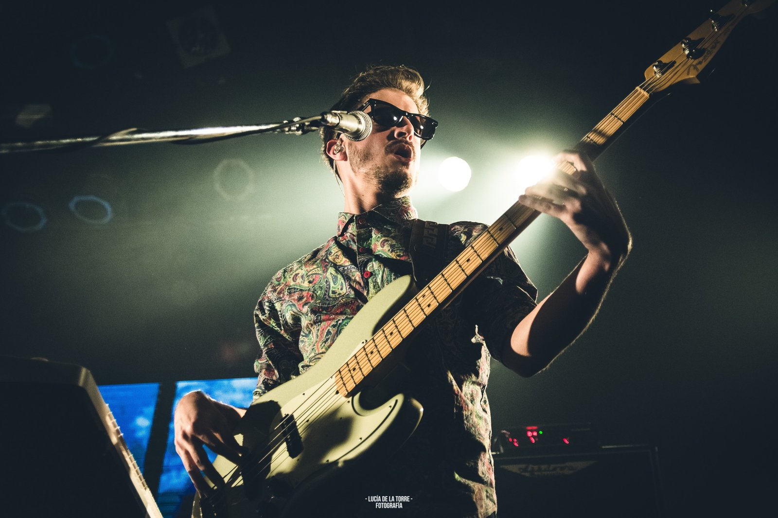 Low angle live photo of Leandro Juarez on bass